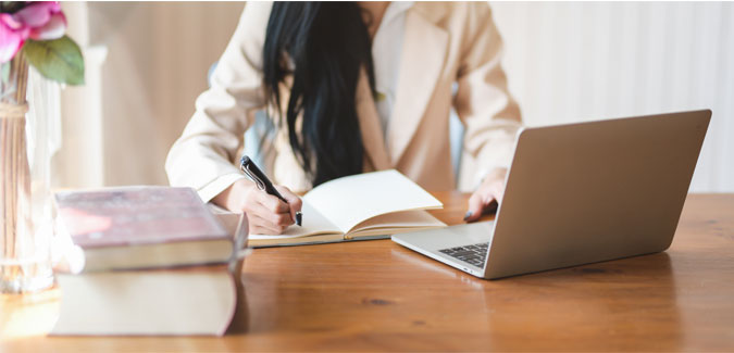 A woman works at a desk. 