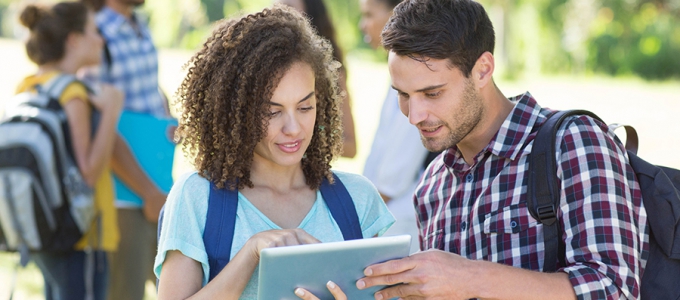 Students looking at a tablet