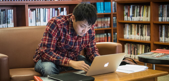 A student studies using a laptop. 